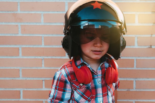 boy wearing helmet against the wall